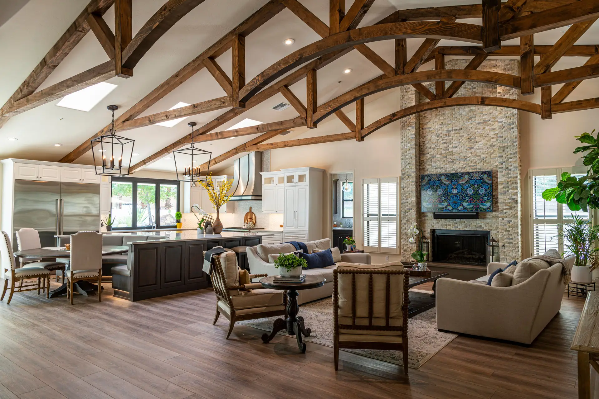 Boutique kitchen and dining area featuring timber ceiling rafters and understated cabinetry