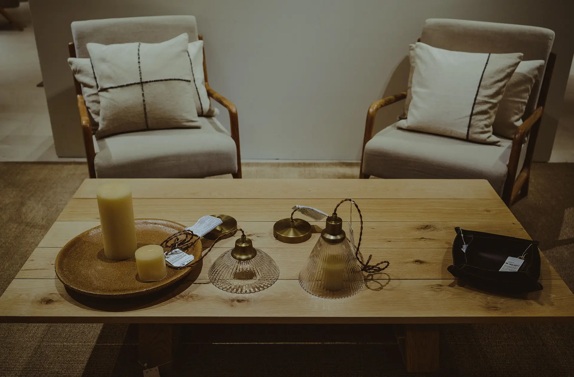 Consultation lounge setting with linen armchairs and warm timber coffee table