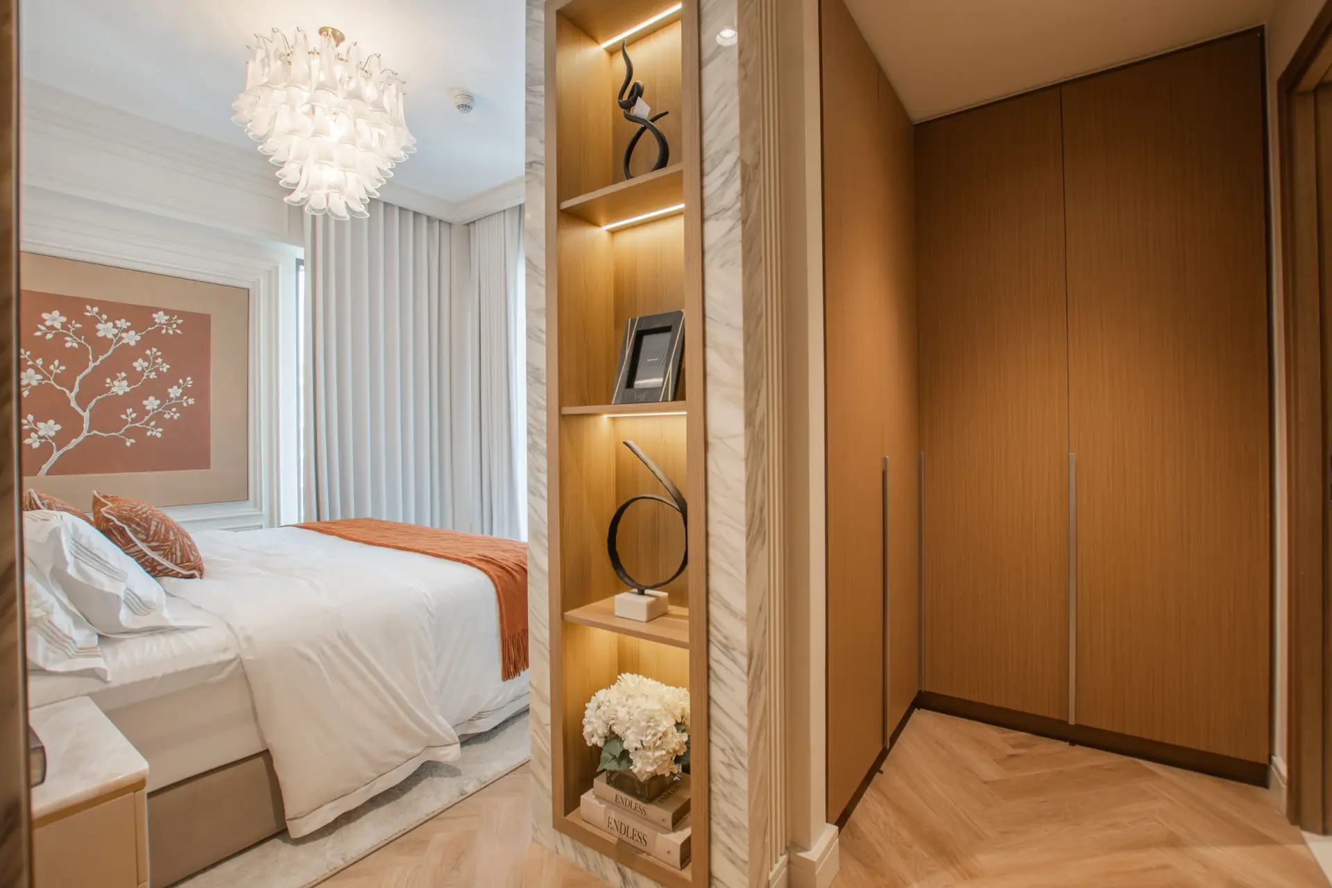 Carefully curated master bedroom with styled bedside lamps and natural woven textiles