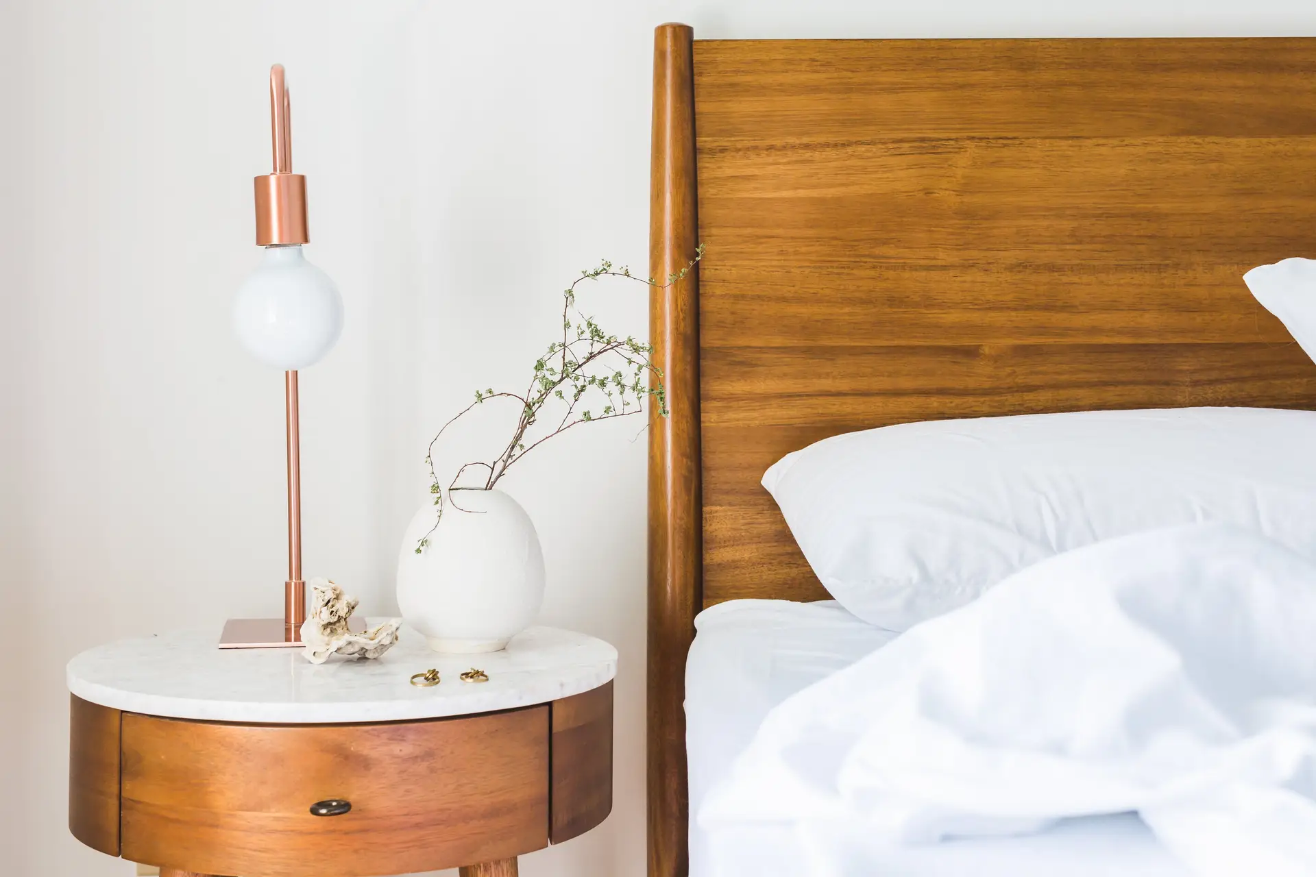Detailed timber joinery, solid oak bed frame, and artisanal lighting fixtures