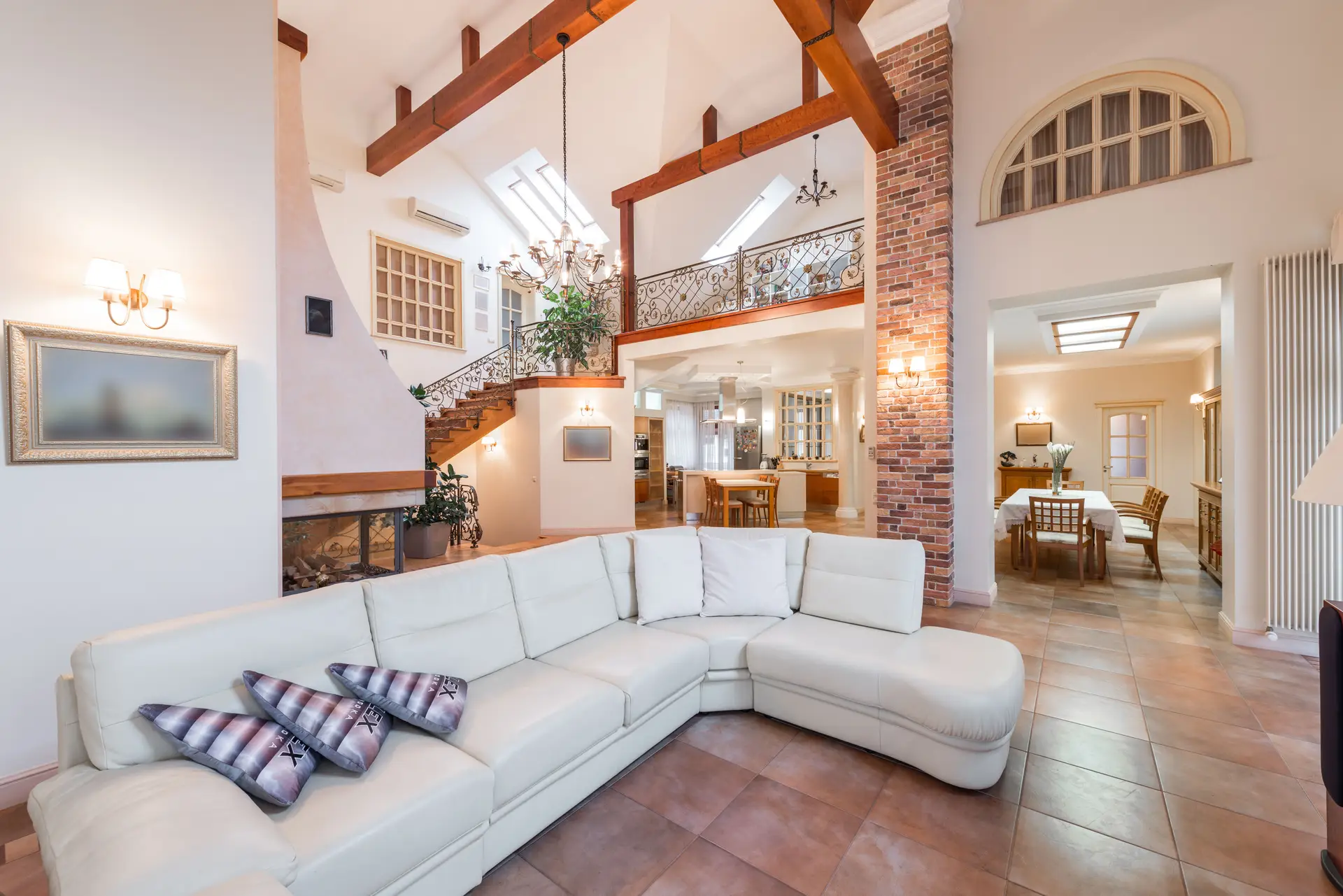Warm, refined open-plan kitchen and dining interior styled with soft timber and pale stone